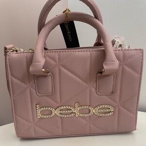 Bebe pink purse with long and short straps.